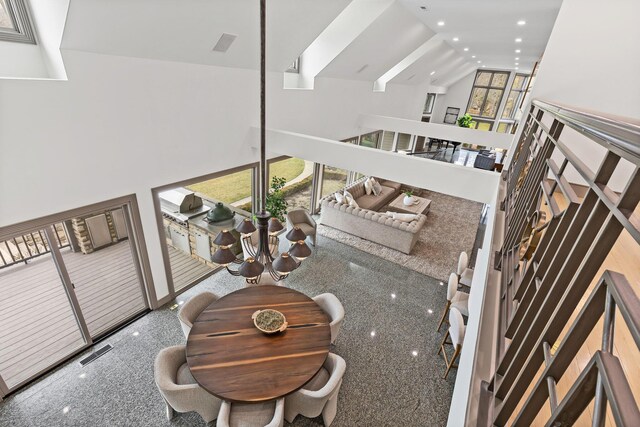 interior space with a high ceiling, recessed lighting, and visible vents