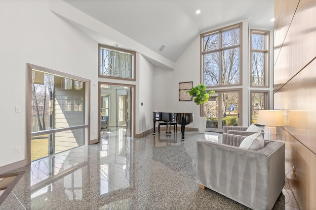 living room featuring recessed lighting, baseboards, high vaulted ceiling, and granite finish floor