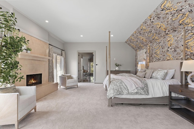 bedroom featuring carpet flooring, recessed lighting, and a tile fireplace