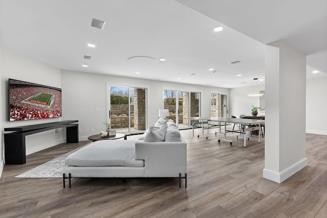 living room with recessed lighting, wood finished floors, and baseboards