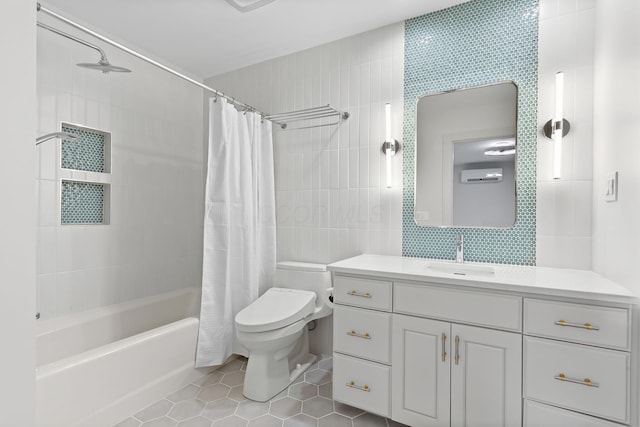 full bath with tile patterned flooring, toilet, vanity, shower / bath combo, and tile walls