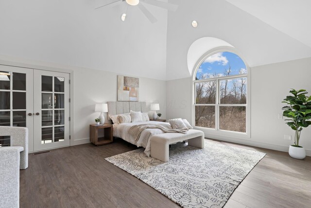 bedroom featuring baseboards, ceiling fan, french doors, wood finished floors, and high vaulted ceiling