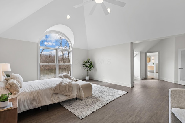 bedroom with dark wood-style floors, baseboards, and high vaulted ceiling