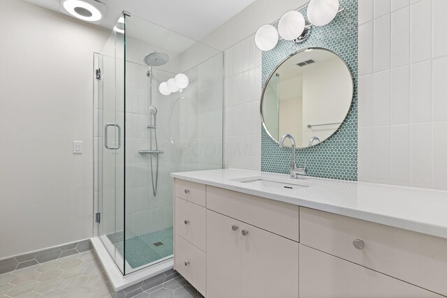 bathroom featuring vanity, tile patterned floors, tile walls, and a stall shower