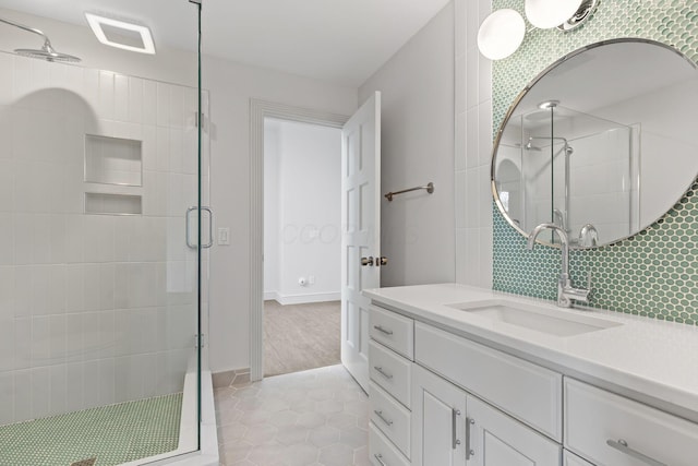 full bathroom with vanity, baseboards, visible vents, tile patterned flooring, and a shower stall