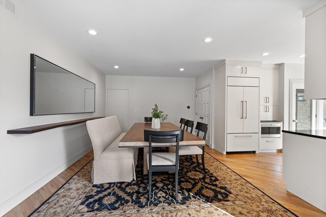 dining area featuring light wood-style flooring, recessed lighting, and visible vents