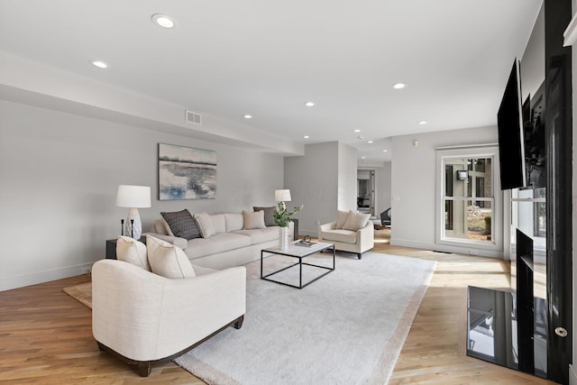 living room featuring recessed lighting, visible vents, and light wood-style flooring