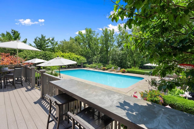 pool featuring outdoor dining area and a deck