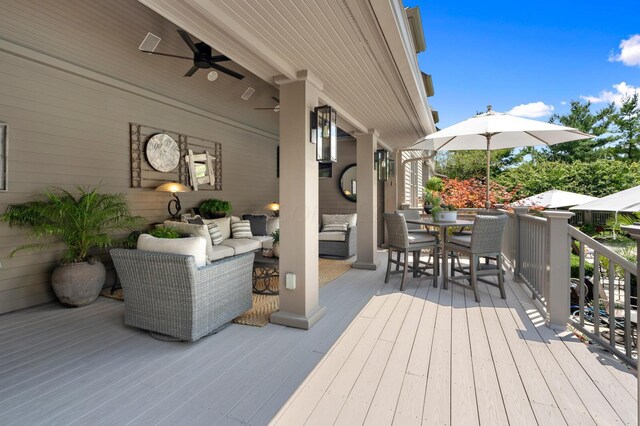 wooden deck featuring an outdoor living space, outdoor dining area, and ceiling fan