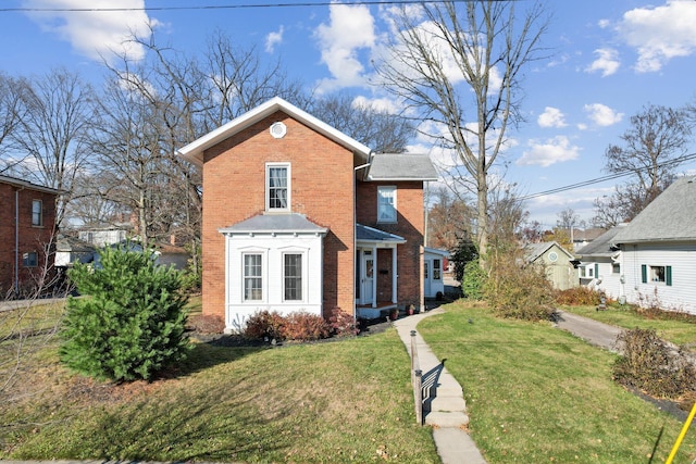 traditional-style home with brick siding and a front yard