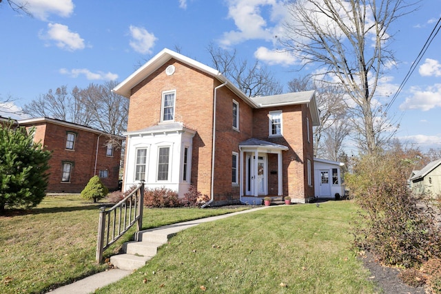 traditional home with a front yard and brick siding