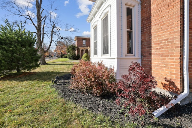 view of property exterior featuring a lawn