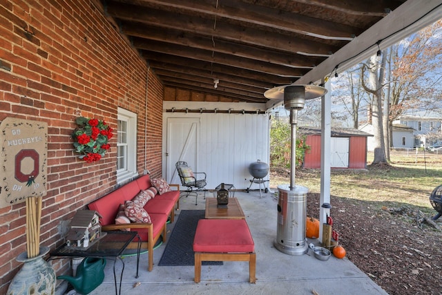 view of patio / terrace featuring outdoor lounge area, an outbuilding, and a storage unit