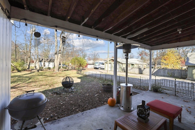 view of patio / terrace featuring grilling area, an outdoor fire pit, and fence