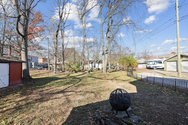 view of yard with a storage unit, an outdoor structure, and fence