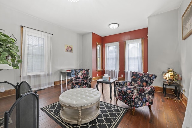 living area featuring hardwood / wood-style floors and baseboards