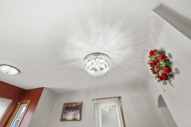 room details with arched walkways and a chandelier