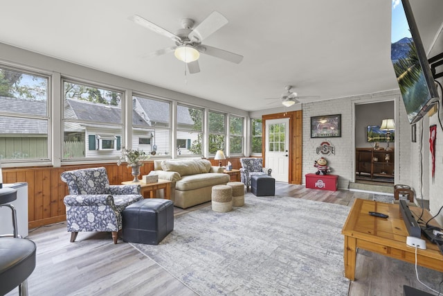 living area with a ceiling fan and light wood finished floors