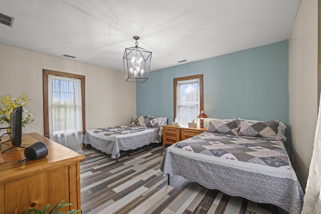 bedroom with visible vents and multiple windows