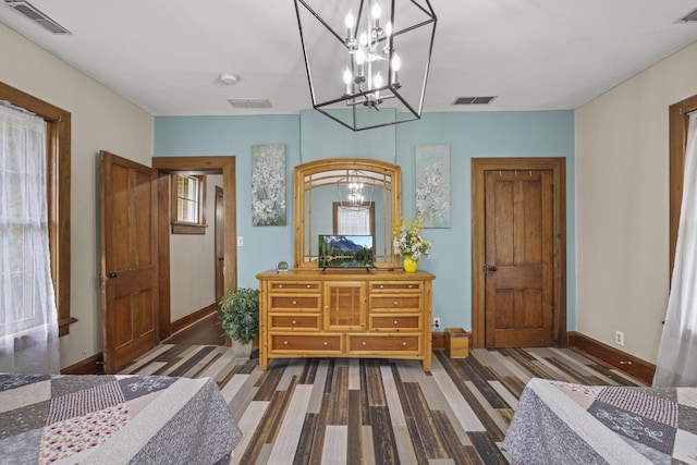 bedroom featuring baseboards and visible vents