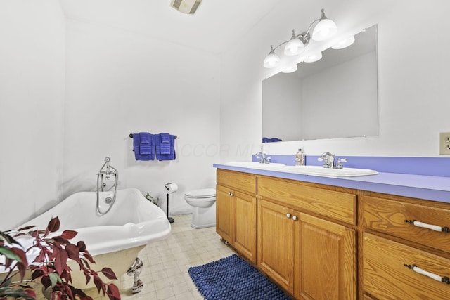 full bath with tile patterned floors, visible vents, toilet, a freestanding bath, and vanity