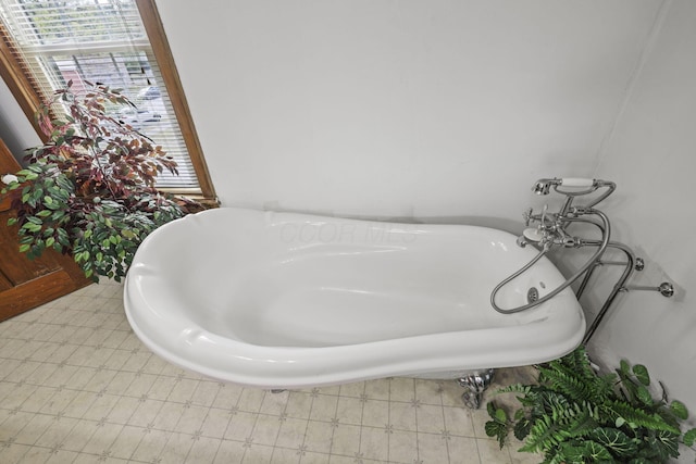 bathroom featuring a soaking tub and tile patterned floors