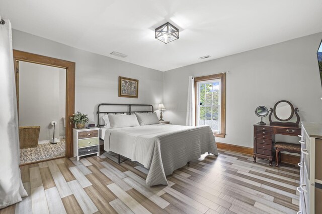 bedroom with visible vents, baseboards, and light wood-style floors