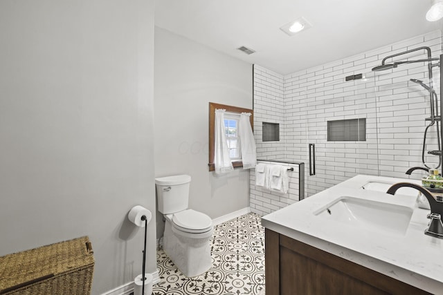 bathroom with visible vents, a shower stall, toilet, tile patterned floors, and a sink