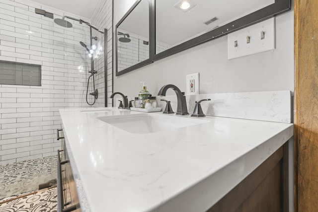 bathroom featuring visible vents, vanity, and a shower stall