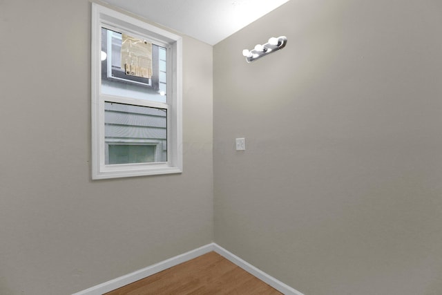 interior space with baseboards and wood finished floors