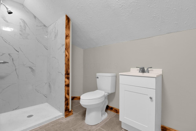 bathroom with a marble finish shower, toilet, vaulted ceiling, a textured ceiling, and vanity