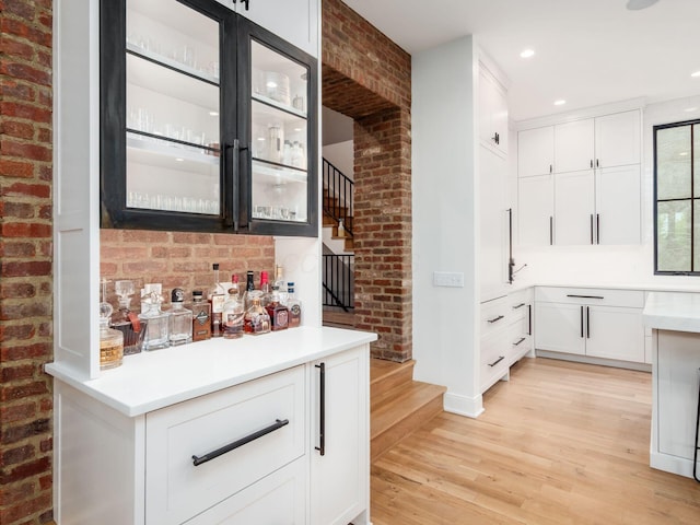 597 S 9th St, Columbus, OH 43206 - indoor dry bar with light wood-style flooring, brick wall, stairs, recessed lighting, and baseboards