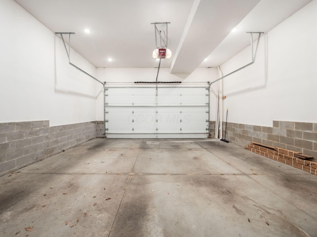 597 S 9th St, Columbus, OH 43206 - garage featuring a garage door opener and a wainscoted wall