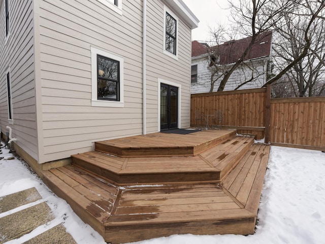 snow covered deck with fence