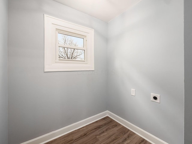 washroom featuring laundry area, dark wood-style floors, baseboards, and electric dryer hookup