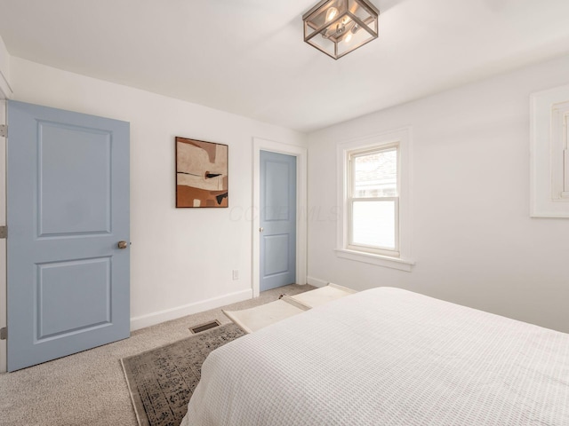 bedroom featuring light carpet, visible vents, and baseboards