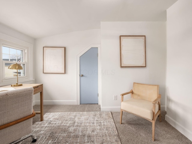 living area featuring carpet and baseboards