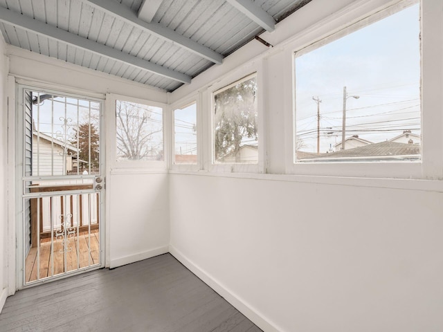 unfurnished sunroom featuring wood ceiling and beamed ceiling