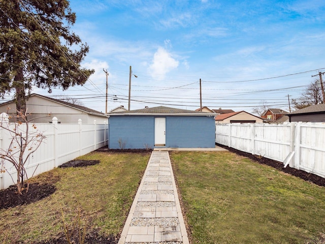 view of yard with an outbuilding and a fenced backyard