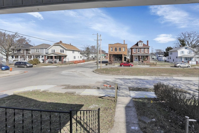 view of road with a residential view and curbs