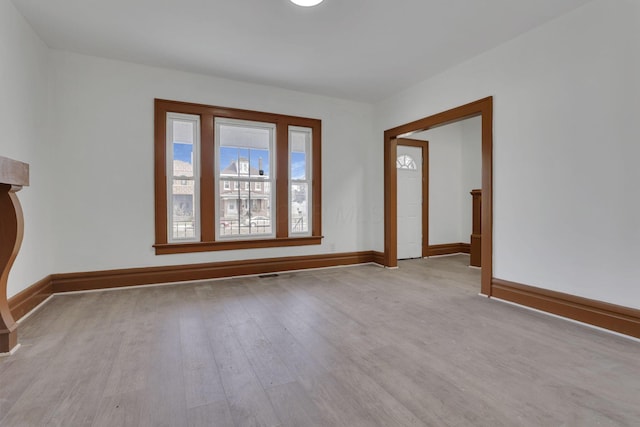 spare room featuring wood finished floors and baseboards