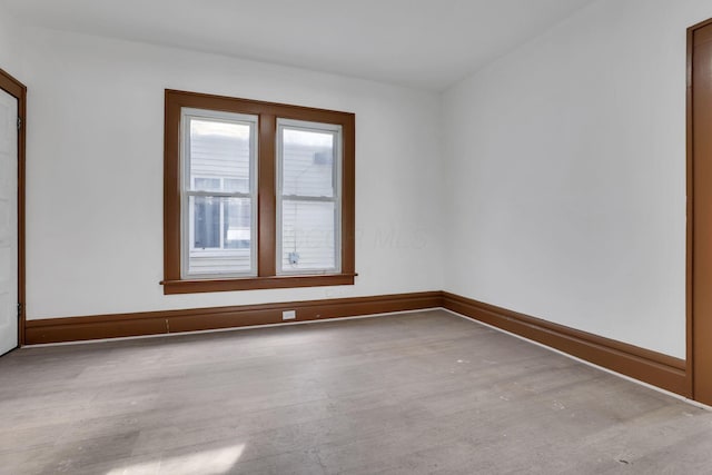 empty room with wood finished floors and baseboards