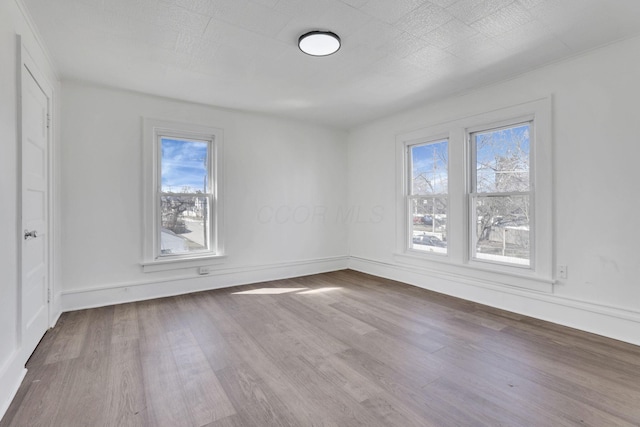 empty room featuring baseboards and wood finished floors