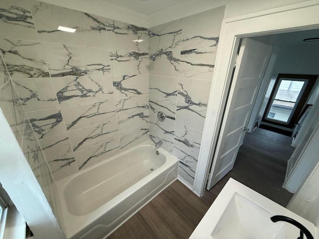 bathroom with shower / bathing tub combination and wood finished floors