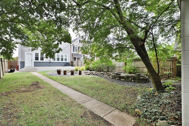 view of yard featuring fence private yard and entry steps