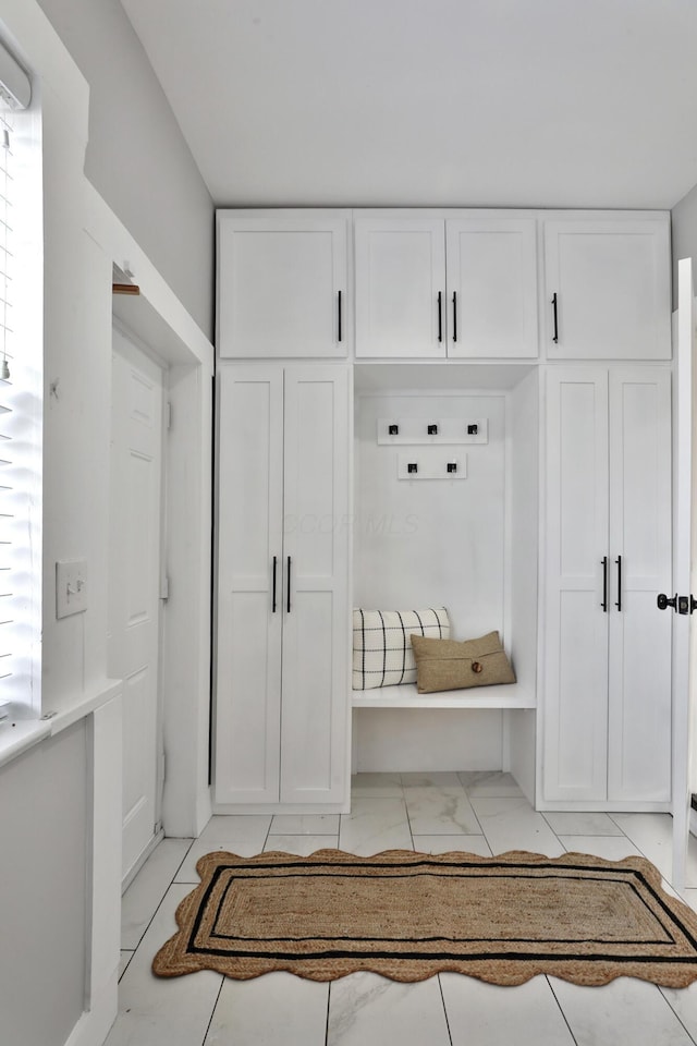 mudroom with marble finish floor