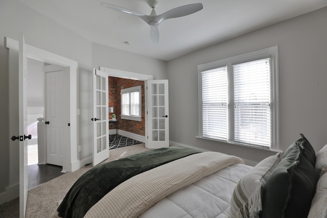 bedroom with ceiling fan, multiple windows, baseboards, and french doors