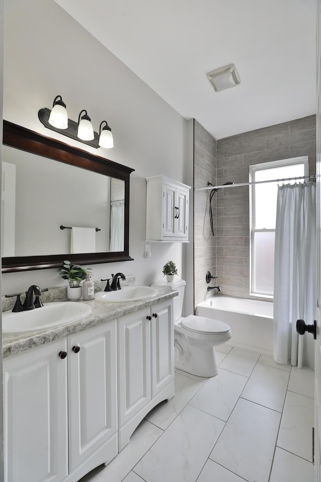 full bath with shower / tub combo, a sink, toilet, and double vanity