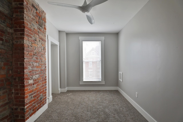 empty room featuring carpet floors, baseboards, and a ceiling fan