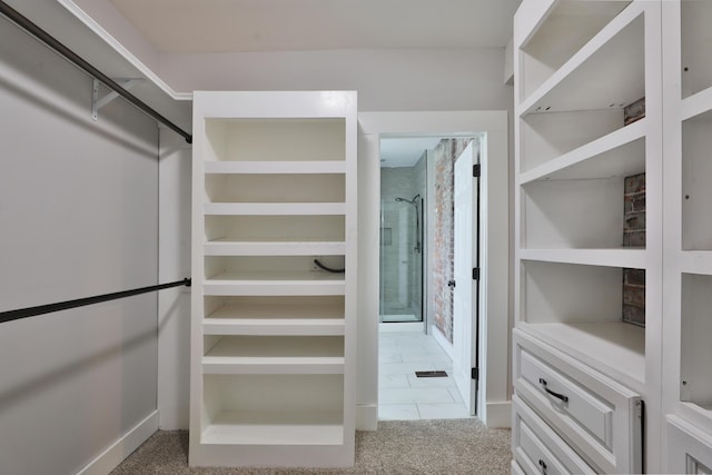 walk in closet with carpet flooring